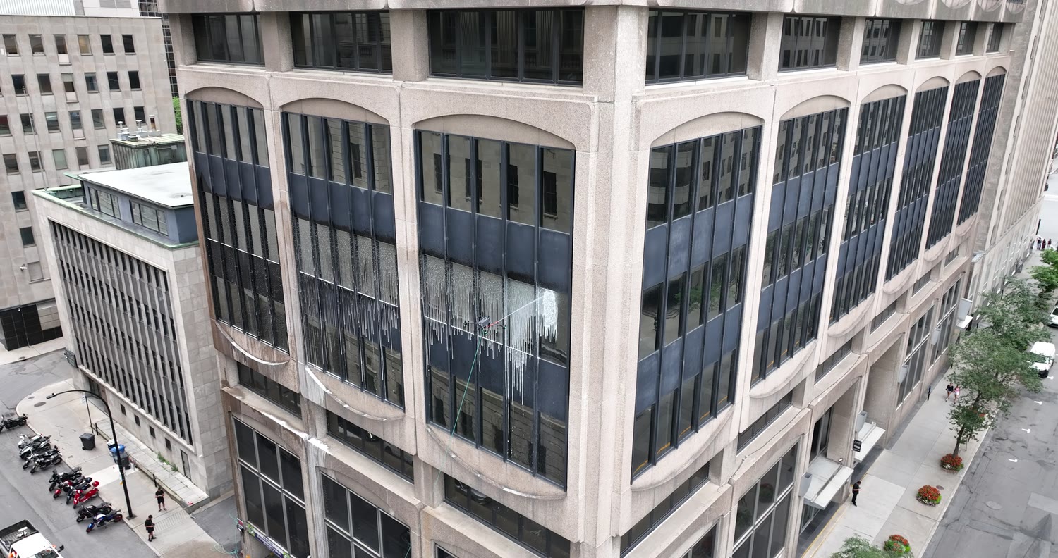 The drone mid-wash on the façade
