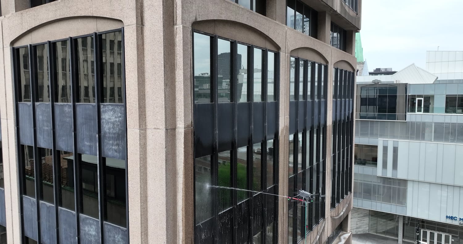 The drone washing beneath the arches, at the corner of the tower