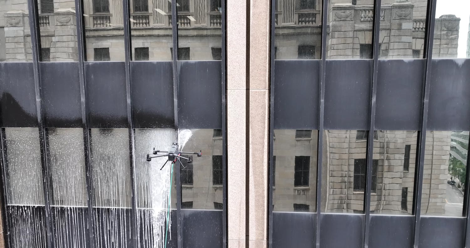 The drone facing the glass, water streaming down